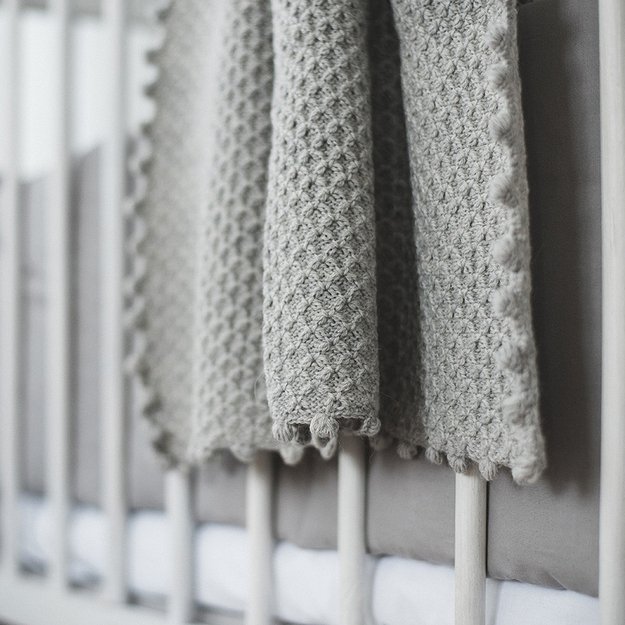 Light grey knitted woolen blanket