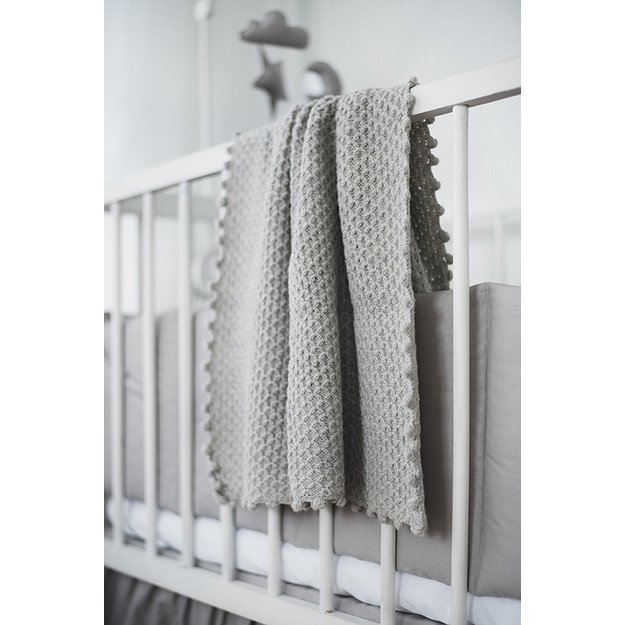 Light grey knitted woolen blanket